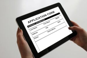 Consolidation applicant holds application form on tablet